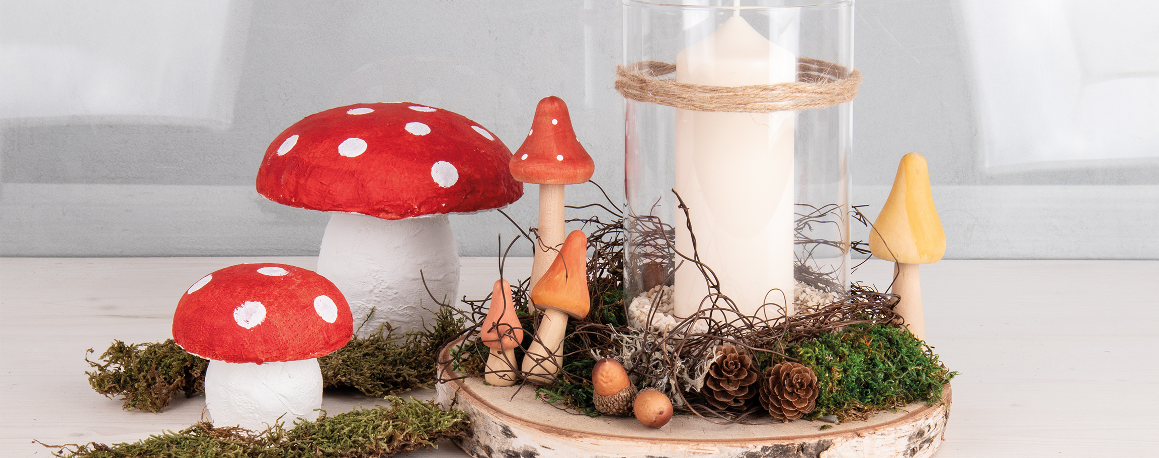 Mushrooms with candle glass on birch wood slice